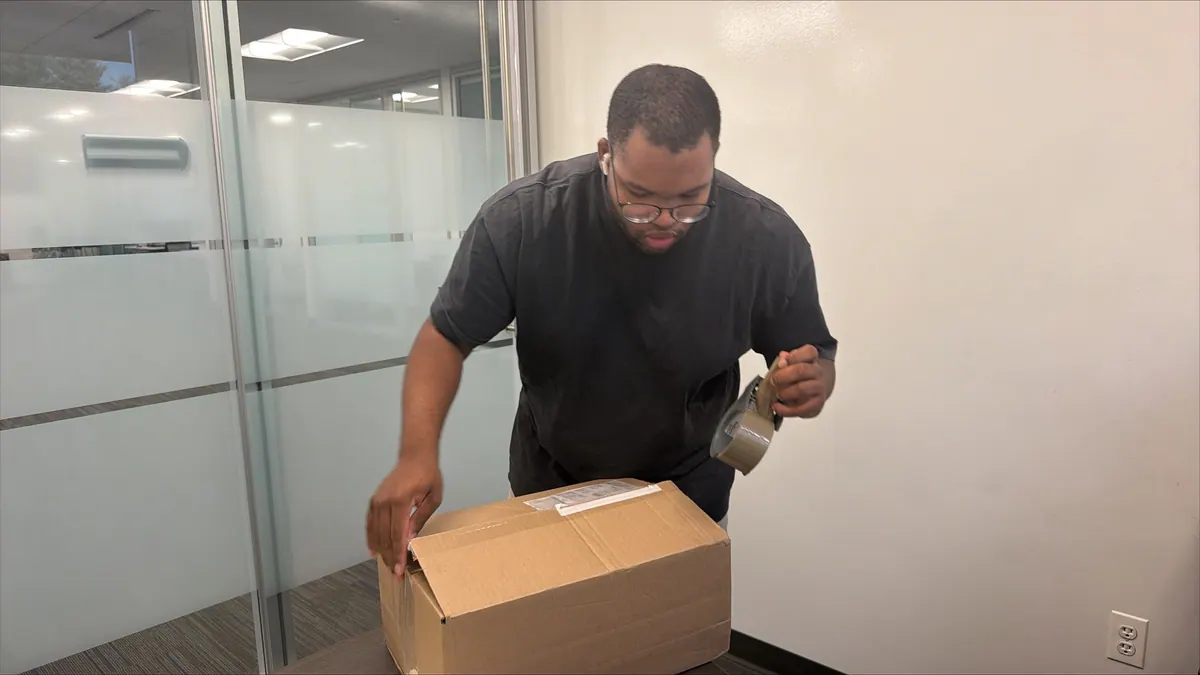 A Princeton Service Center technician packing a shipping box