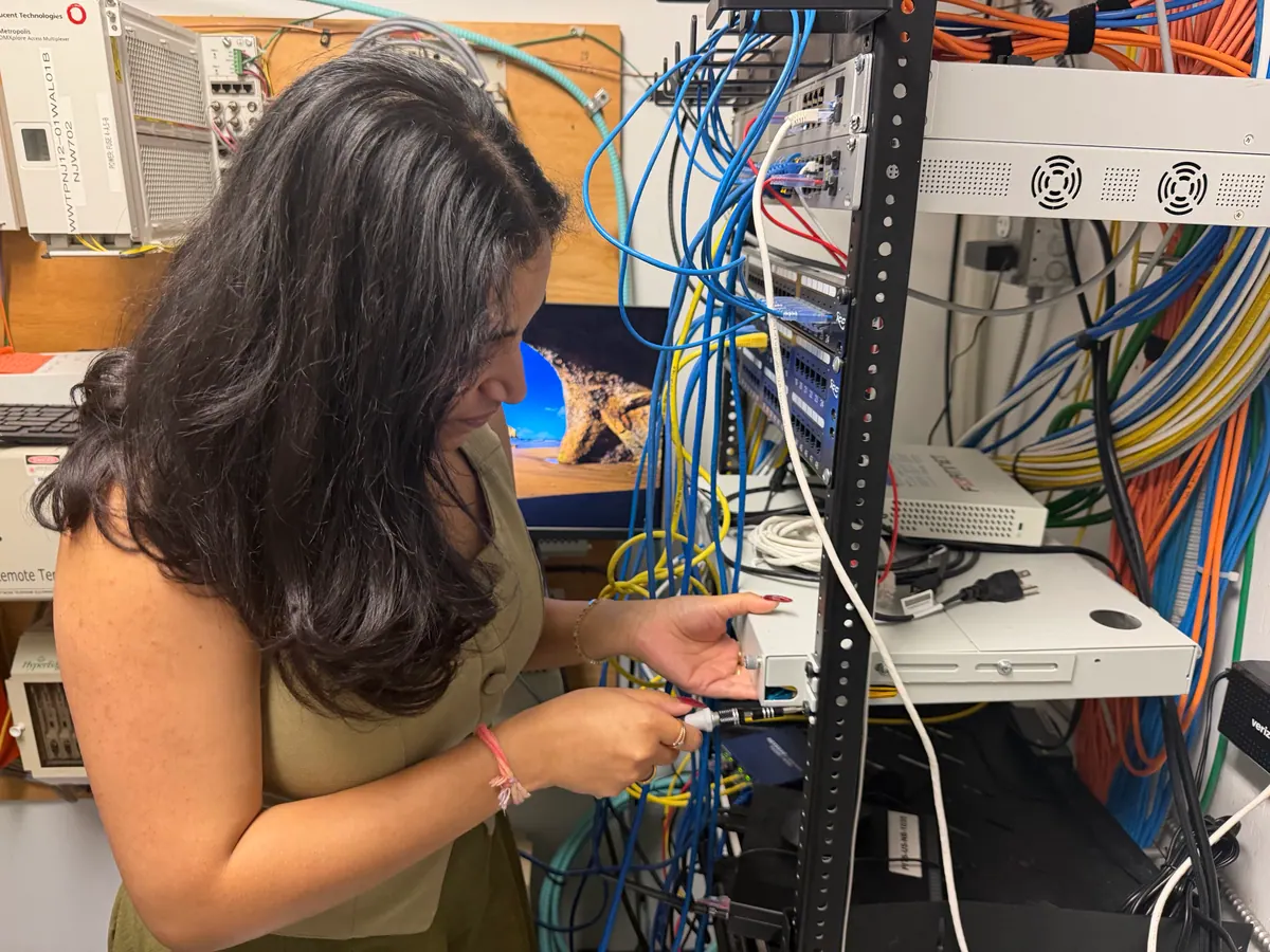 A Princeton Service Center technician connecting network equipment in a client's server rack