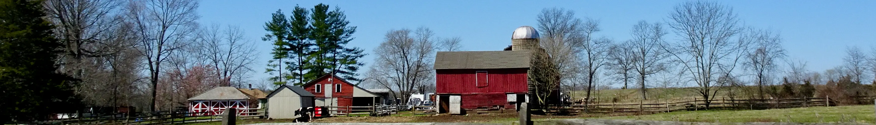 A red barn and silo on a farm in Montgomery Township